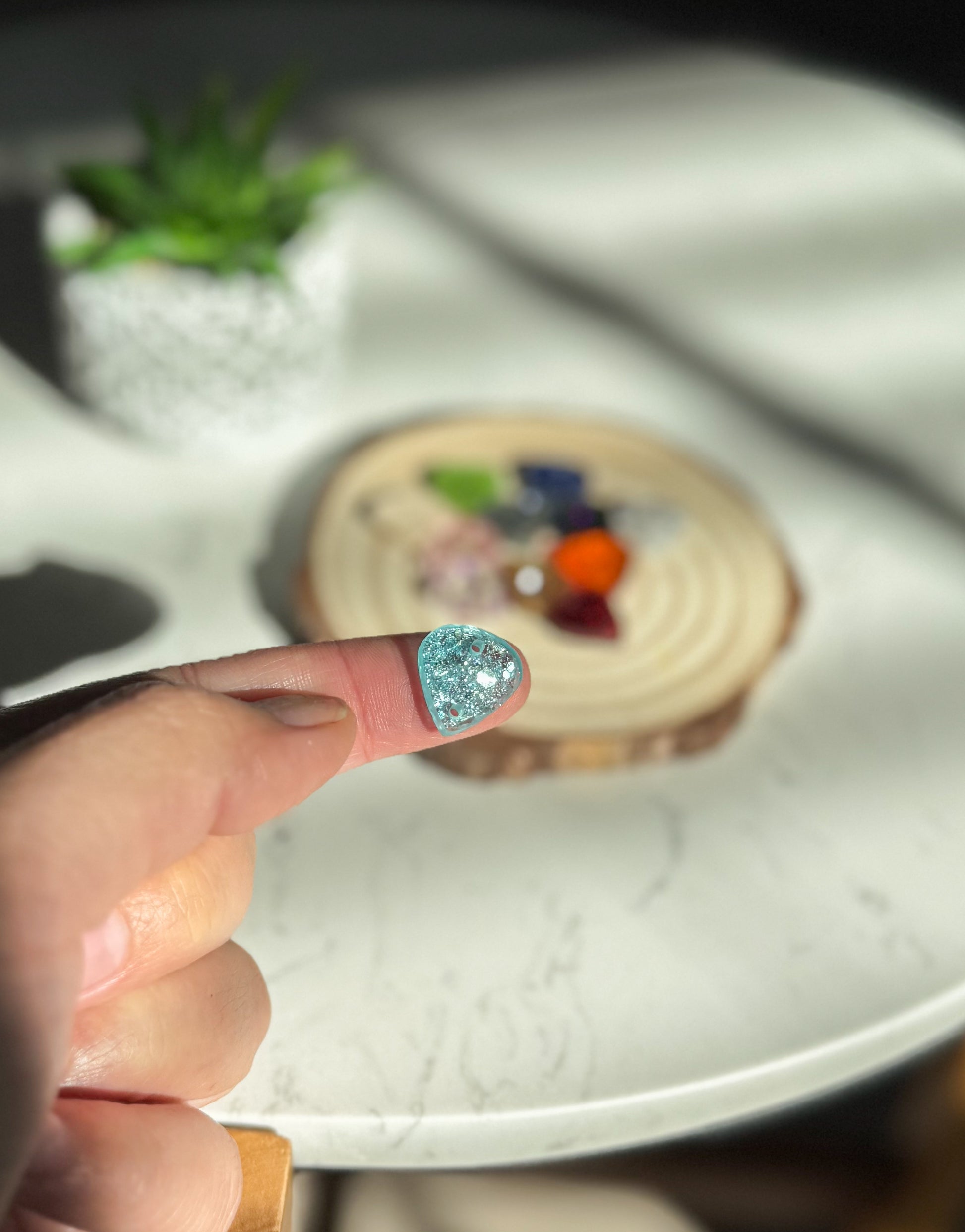 Close-up of a hand holding a small charm.